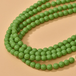 Macro shot of 8mm polished green glass beads showing smooth texture for DIY jewelry