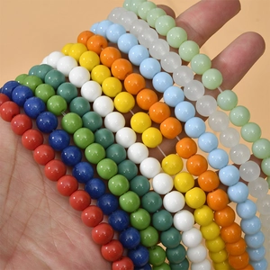 Close-up of colorful 8mm round glass beads for DIY jewelry making held in hand