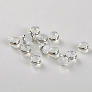 Set of clear silicone and gold metal ring earring back stoppers on grey background