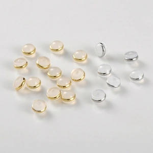 Close-up of silicone and 18k gold plated flying saucer earring backs for DIY jewelry making
