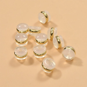 Close-up of clear silicone earring backs with 18k gold-plated rings for DIY jewelry