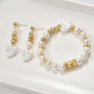 Elegant gold woven bead jewelry set with pearl bracelet and heart pendant earrings