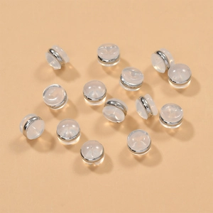 Close-up of clear silicone earring backs with 18k gold-plated rings for jewelry making