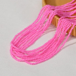 Macro detail of 3mm pink faceted macaron glass beads for DIY jewelry making