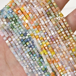 Detailed view of colorful 2mm square faceted glass beads with iridescent AB coating