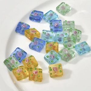 Detail of square glass flower beads with pink rose patterns for DIY jewelry making