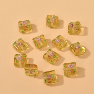 Macro detail of yellow square glass flower beads for handmade jewelry making