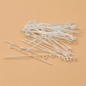 Detailed view of silver 9-shape eye pins for DIY jewelry making and beadwork