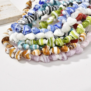 Macro detail of handmade heart-shaped glass beads with swirl textures for DIY jewelry