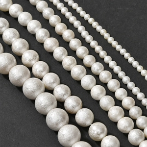 Macro view of five sizes of pearl beads with matte texture for DIY jewelry making