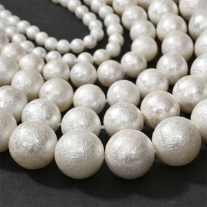 Multiple sizes of white textured cotton pearls with unique wrinkled finish for jewelry DIY