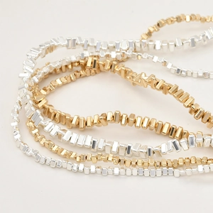 Minimalist gold and silver layered beaded chain necklace with geometric beads