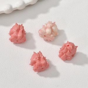 Detailed view of pink hand-carved sea bamboo fox beads for DIY jewelry making