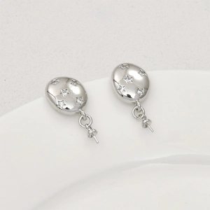 Macro view of silver star pattern oval earring posts with cubic zirconia for DIY jewelry