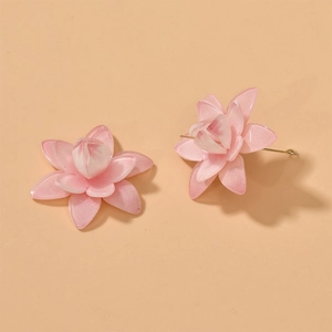 Detail view of pink acrylic lotus earrings with gradient petals and golden studs