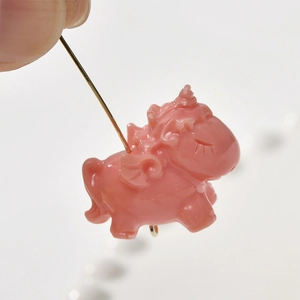 Detailed macro of pink unicorn pendant accessory for DIY jewelry with metal loop
