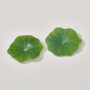 Detail of green acrylic lotus leaf charms with lifelike water drops for DIY jewelry