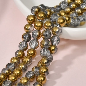Close-up of 8mm gray crackle quartz beads and golden mirror finish spacer beads for DIY jewelry