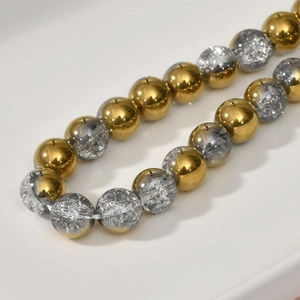 Macro view of 8mm gold electroplated beads and grey crackle glass beads for DIY jewelry