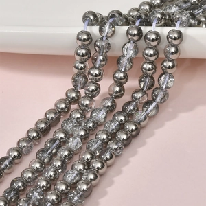 Macro view of 8mm silver plated cracked glass and polished metal beads for jewelry