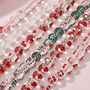 Macro shot of glass beads with Christmas sock and snowflake patterns for DIY jewelry