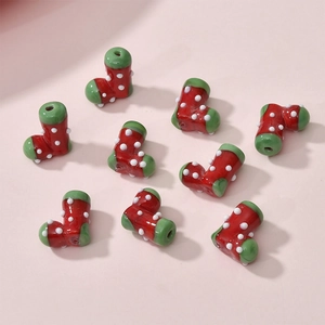 Macro detail of Christmas stocking glass beads for DIY jewelry with festive red and green dots