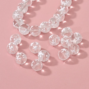Macro shot of translucent glass beads with white star patterns for DIY jewelry making
