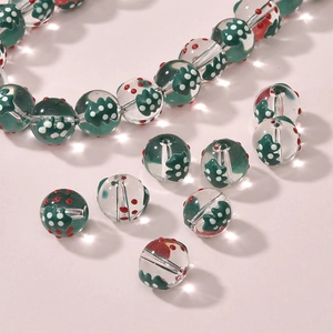 Macro view of transparent Christmas glass beads with festive red and green polka dots