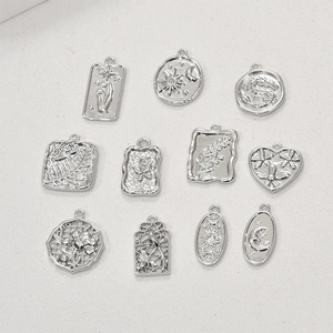 Assorted vintage silver pendants with celestial and floral motifs for DIY jewelry