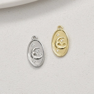 Detail of moon and star charms in gold and silver finish for DIY jewelry making