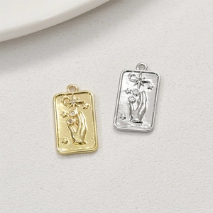 Macro view of gold and silver tarot style rectangular pendants with celestial star patterns