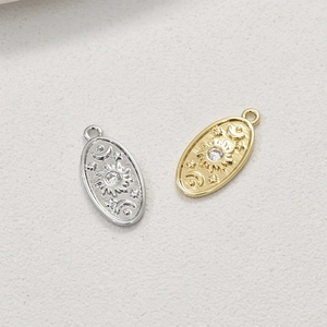 Macro detail of 14k gold and silver star moon oval pendants with zircon for DIY jewelry