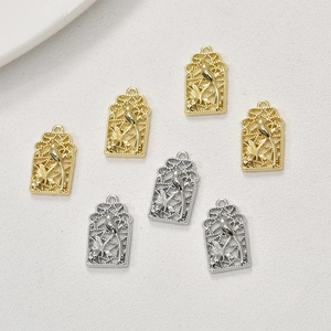 Macro detail of bird cage style gold and silver charms for DIY jewelry making