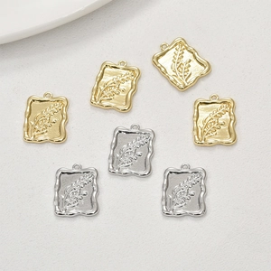 Detailed view of 14k gold and silver wheat pattern flower pendants for DIY jewelry making