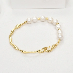 Detail of 14k gold plated irregular twig bracelet with lustrous white pearls and hook clasp
