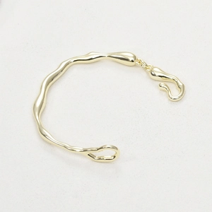 Irregular 14k gold plated branch bangle with minimalist organic fluid wave design