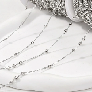 Polished silver beaded chain on spool for DIY jewelry making and necklace crafting
