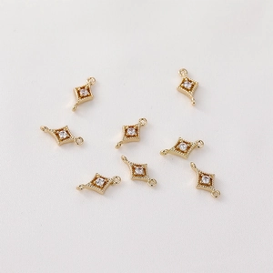 Detailed macro of 14K gold-plated star charms with pavé cubic zirconia for DIY jewelry