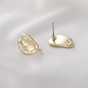 Close-up of S925 sterling silver ear studs with baroque hammered gold texture and loop