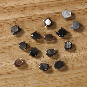 Macro shot of natural black shell cat-shaped charms for DIY jewelry and earrings