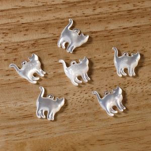 Detail view of 6 shell cat charms with iridescent luster for DIY jewelry making