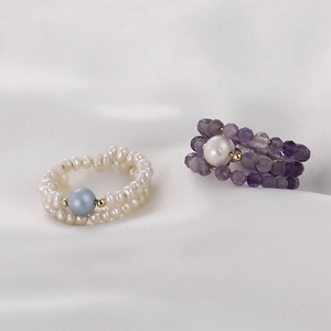 Elegant beaded memory wire rings with white pearls and faceted purple amethyst stones