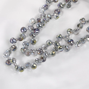 Macro view of faceted teardrop crystal beads with iridescent shimmer for DIY jewelry making