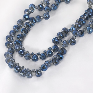 Close-up of faceted navy blue crystal beads showing intricate light-reflecting cuts