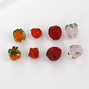 Detailed macro view of handmade glass fruit beads for DIY jewelry making and earrings