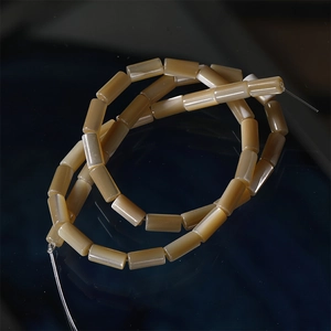 Macro detail of translucent light brown cylindrical beads with natural oily texture