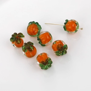 Macro detail of handmade orange persimmon glass beads for DIY earring jewelry making