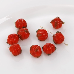 Detailed macro of red persimmon glass beads with hole structure for jewelry DIY
