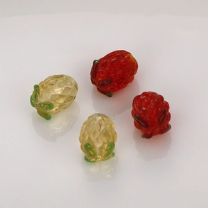 Macro shot of 4 translucent glass pineapple charms with green leaves and diamond patterns