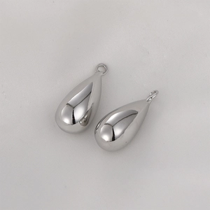 Macro detail of teardrop silver charms with mirror polish for DIY jewelry making